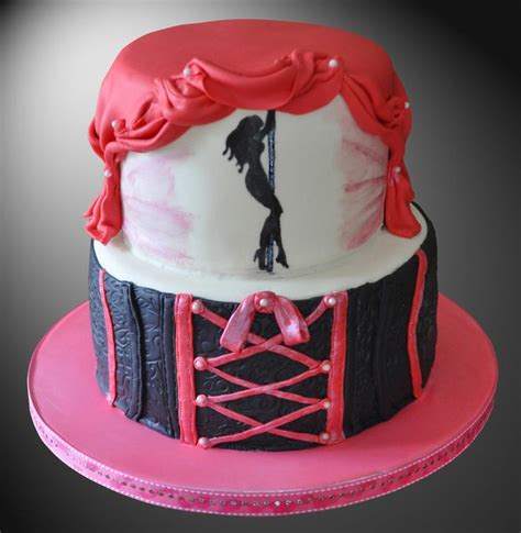 A Cake Decorated With An Image Of A Woman On A Stage And Pink Ribbon