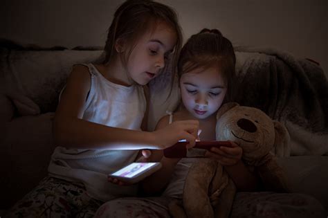 Zwei Kleine Mädchen Sitzen Nachts Im Bett Und Nutzen Smartphones