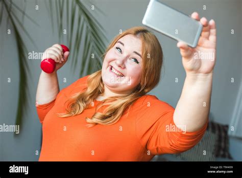 Chubby Woman Sport At Home Standing Holding Dumbbell Taking Selfie