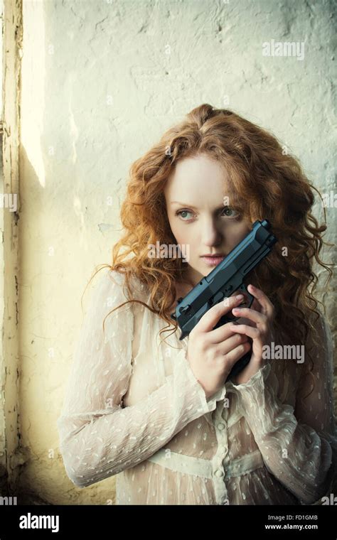 Girl Holding Guns Hi Res Stock Photography And Images Alamy