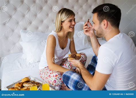 Young Couple Having Having Romantic Times In Bedroom Stock Photo