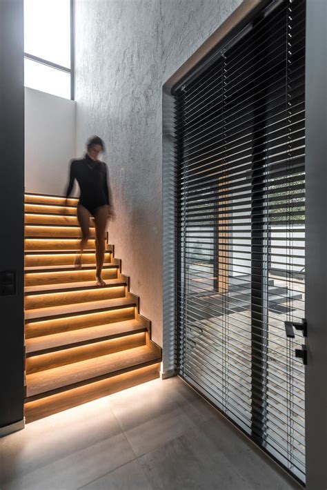 A Strip Of Led Lights Under The Stairs Of This Home Adds A Warm Glow To