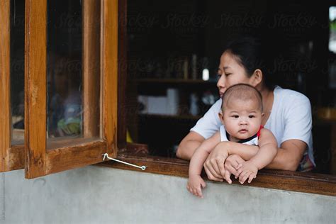 Asian Mom And Her Son Sitting By The Window By Stocksy Contributor