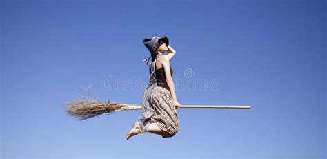 Young Red Haired Witch On Broom Flying In The Sky Stock Photo Image