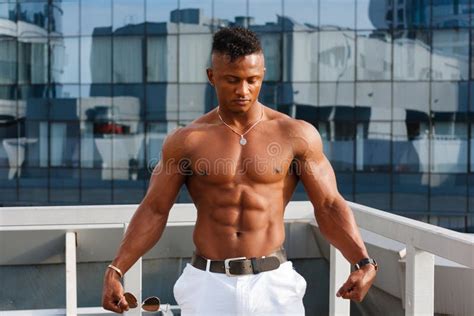 Hot Beautiful Black Guy With Bulging Muscles Posing Against The