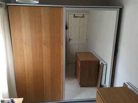 Combination of shelving and cupboards. IKEA sliding door double wardrobe - oak and mirror doors ...