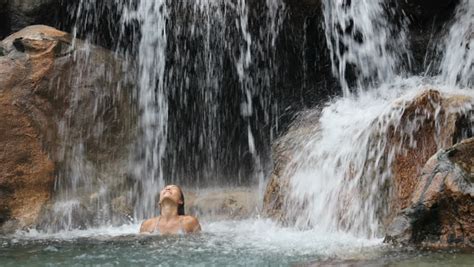 Sexy Bikini Woman In Tropical Paradise Standing Under Waterfall