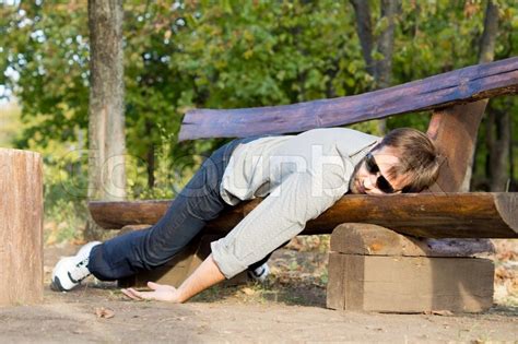Exhausted Man Sleeping On Bench Stock Photo Colourbox