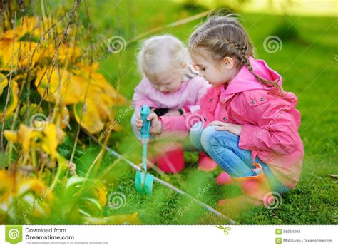 Two Little Girls Helping In A Garden Stock Image Image Of Adorable
