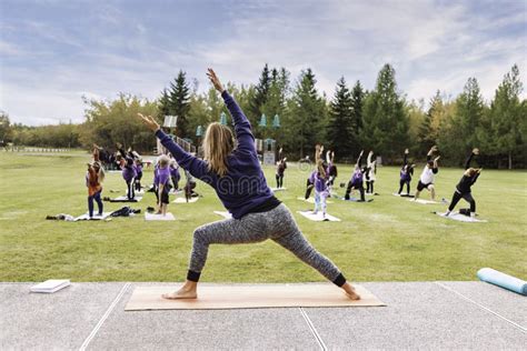 Outdoor Yoga Classes Group Of Adults Attending Yoga Classes In The