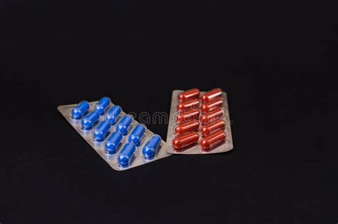 Two Blue And Red Tablets On A Black Background Stock Photo Image Of