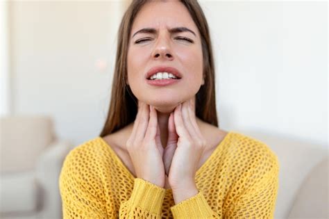 Premium Photo Close Up Of Young Woman Rubbing Her Inflamed Tonsils