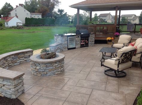 Stamped Concrete Patio With Stone Veneer Wall Grill Station And Fire