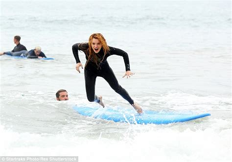 Bella Thorne Slips Into A Tight Fitting Wetsuit As She Learns To Surf