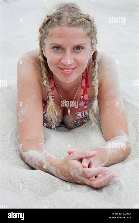 Woman Lying In Sand On Beach Stock Photo Alamy