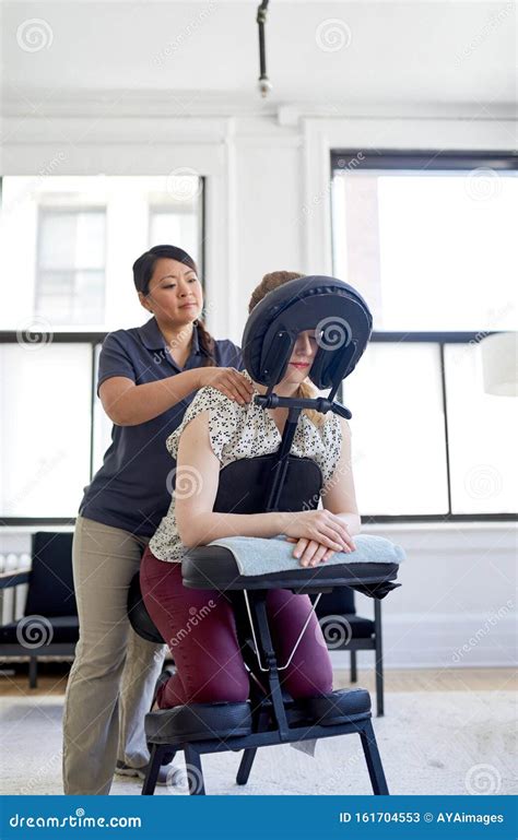 Chinese Woman Massage Therapist Giving A Neck And Back Pressure Stock Image Image Of Neck