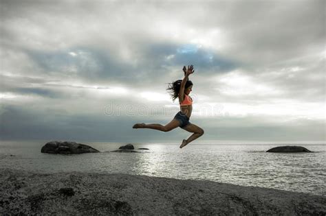 Woman Jumping On A Rock At Sunset On Bakovern Beach Cape Town Stock Photo Image Of Seascape