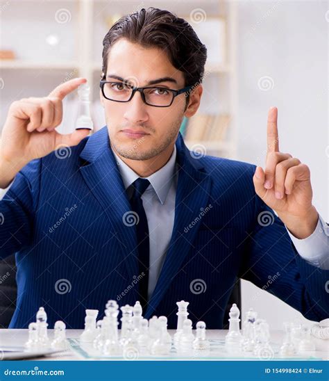 Young Businessman Playing Glass Chess In Office Stock Photo Image Of