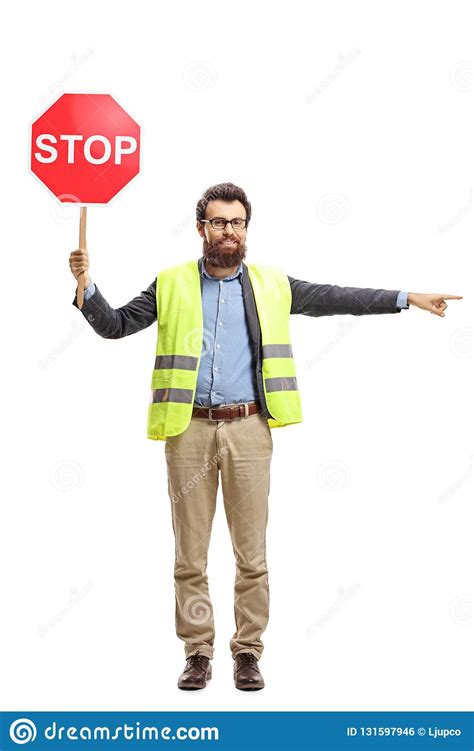 Full Length Portrait Of A Man With A Safety Vest Holding Stop Sign And