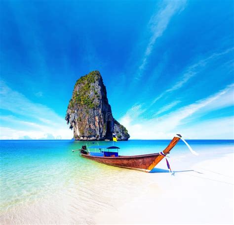 Scenic Getaway Background Of Thai Boat On Exotic Sea Beach Stock Photo