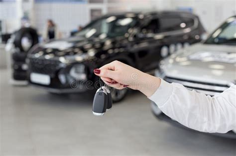 Saleswoman Holding Keys To A New Car Car Auto Dealership Stock Photo