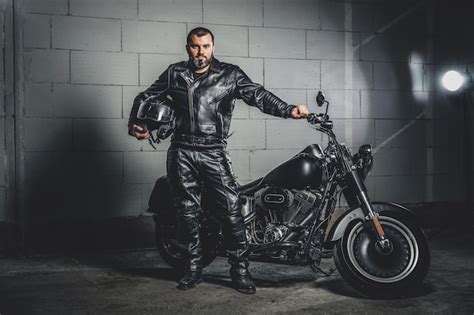 Premium Photo Brutal Bearded Biker In Leather Suit Is Standing Next