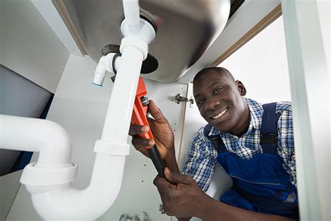 Plumbing uses pipes, valves, plumbing fixtures, tanks, and other apparatuses to convey fluids. African Plumber Stock Photos, Pictures & Royalty-Free ...