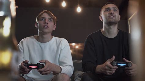 Portrait Two Guys Playing Video Game In The Gaming Room Sitting On The