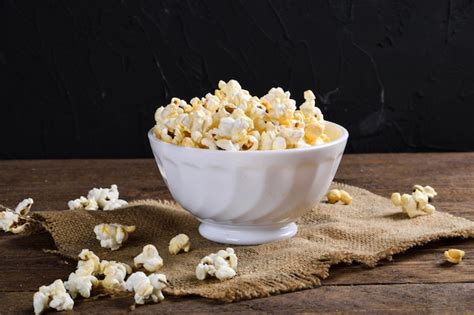 Premium Photo Air Salty Popcorna Bowl Of Popcorn On A Wooden Table