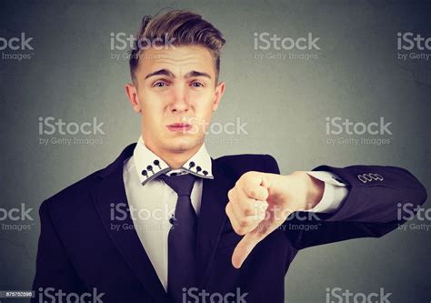 Angry Disappointed Young Business Man Showing Thumbs Down Sign In