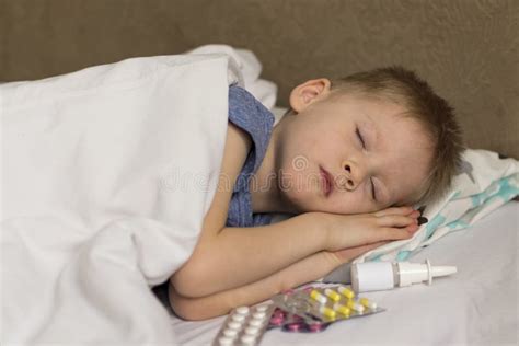 A Sick Child With A Fever And A Headache Lies In Bed The Child Sleeps