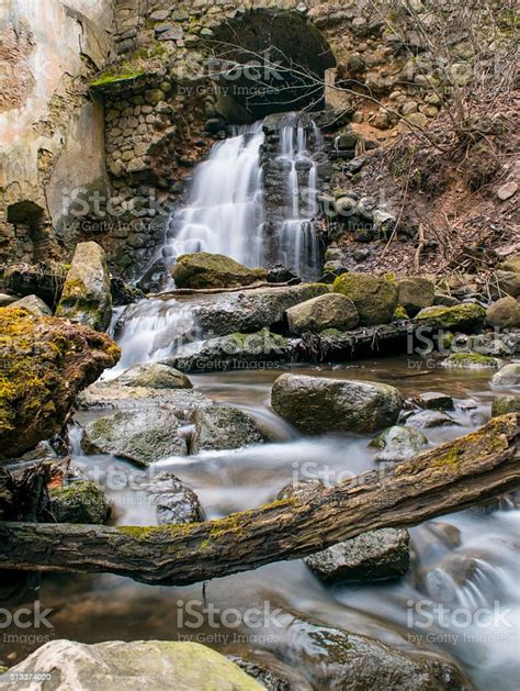 Waterfall From The Arch At Abandoned Place Stock Photo Download Image
