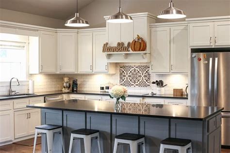 The combination of white kitchen cabinets with wood countertops is a beautiful effect that can be presented in a variety of different ways depending on the intensity and color of the stain that is used. A picture of a kitchen with white cabinets, black ...