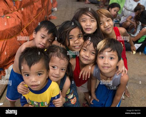 A Group Of Filipino Children Pose For A Picture Within The Taboan