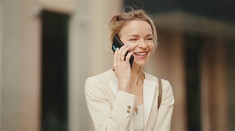 Close Up Smiling Businesswoman With Blond Hair Talking On Cellphone