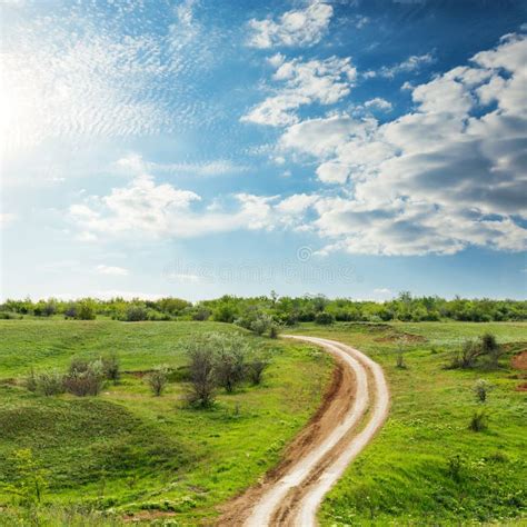 Road In Green Meadow Under Clouds In Blue Sky Stock Image Image Of