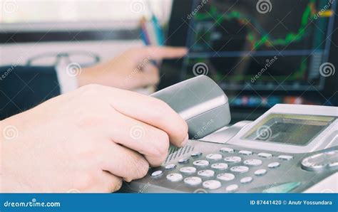 Broker Making Phone Call To Stock Trader To Make Plans Stock Photo
