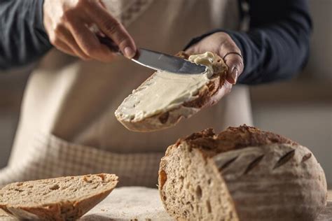 Premium Photo A Woman Makes Delicious Bread Spreads Cream Cheese With