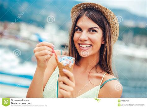Woman Eating Ice Cream Outside On Summer Vacation In Holiday Resort