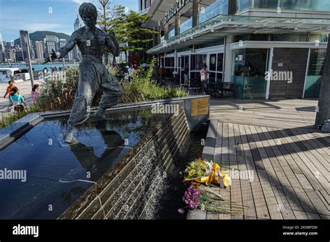 Flowers are seen in front of the statue of Bruce Lee in Tsim Sha Tsui