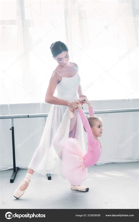 Young Ballet Teacher Helping Little Student Stretching Training Ballet