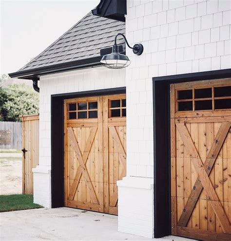 Wood Rustic Farmhouse Garage Doors White Siding Black Roof Logcabin