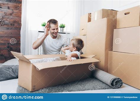 Moving Concept Father And Son Moving To A New Home Stock Photo Image