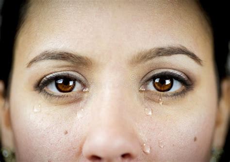 Closeup Shot Of An Emotional Female Crying While Looking At The Camera