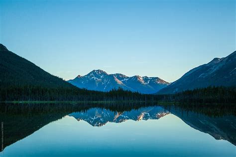 Sunset Reflection Of Mountains On Still Lake By Stocksy Contributor