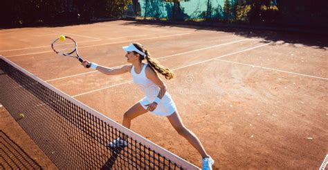 Woman Hitting The Tennis Ball On The Court Stock Photo Image Of