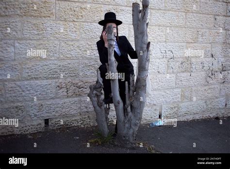 An Ultra Orthodox Jew Watches The Funeral Procession Of Rabbi Of The