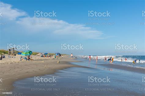 People Relax On The Beach And Swim In The Surf Of The Lifeguarded Beach