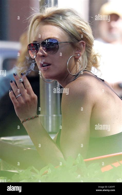Lindsay Lohan Smokes Cigarettes And Chats With A Friend At A Pizzeria Where She Had Lunch During