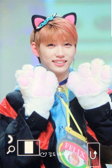 A Person Wearing Cat Ears And Holding Up Their Hands